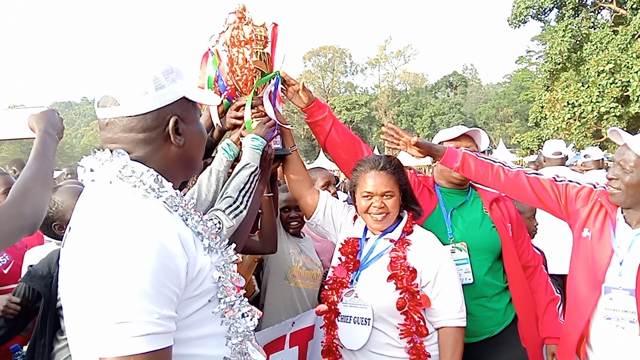 Govt reaffirms commitment to school sports talent development 3 Early Childhood Development Education Director Mdm Martha Odundo (at the centre)awards a trophy to Rift Valley Region officials for emerging overall winners in this year's KPJSSA-SPORTS Championship held in Maseno School. Photo by Peter Amos