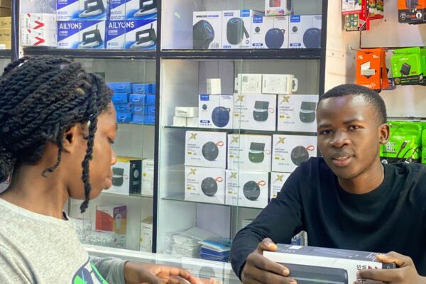 Silvester Ooko, a student entrepreneur, offers electronic repair services during his free time at Skylink Electronics.