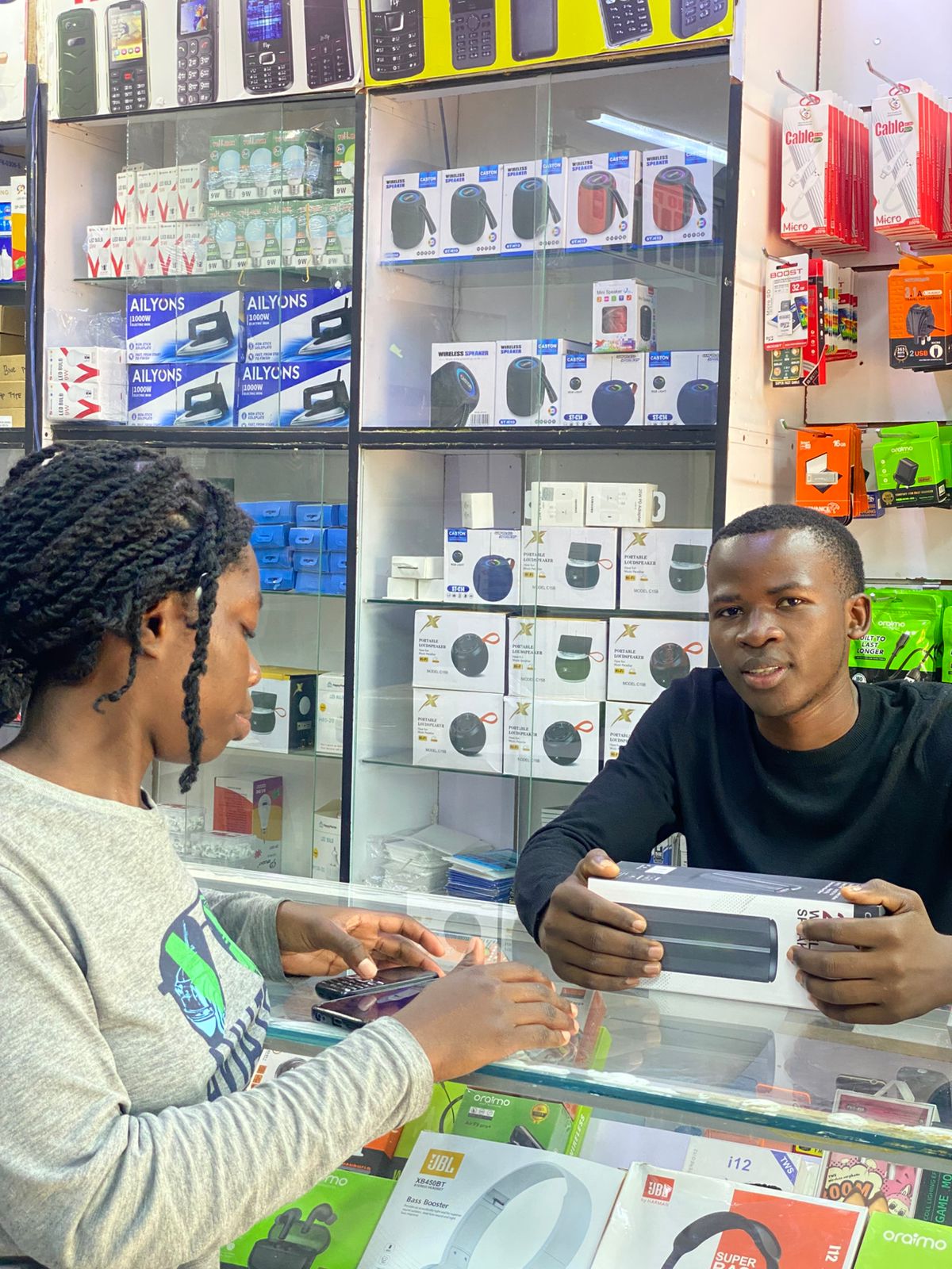 Silvester Ooko, a student entrepreneur, offers electronic repair services during his free time at Skylink Electronics.