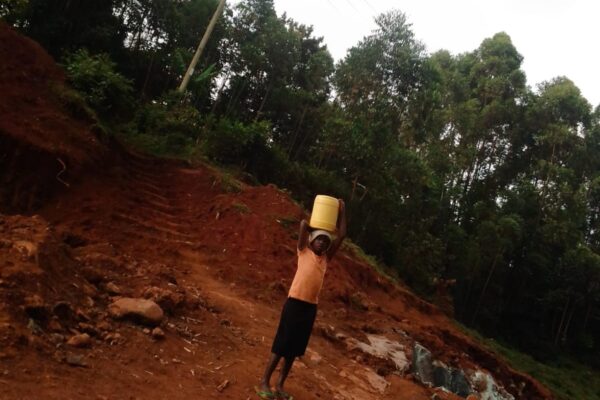 A girl fetching water from the Quarry pit at Magenche