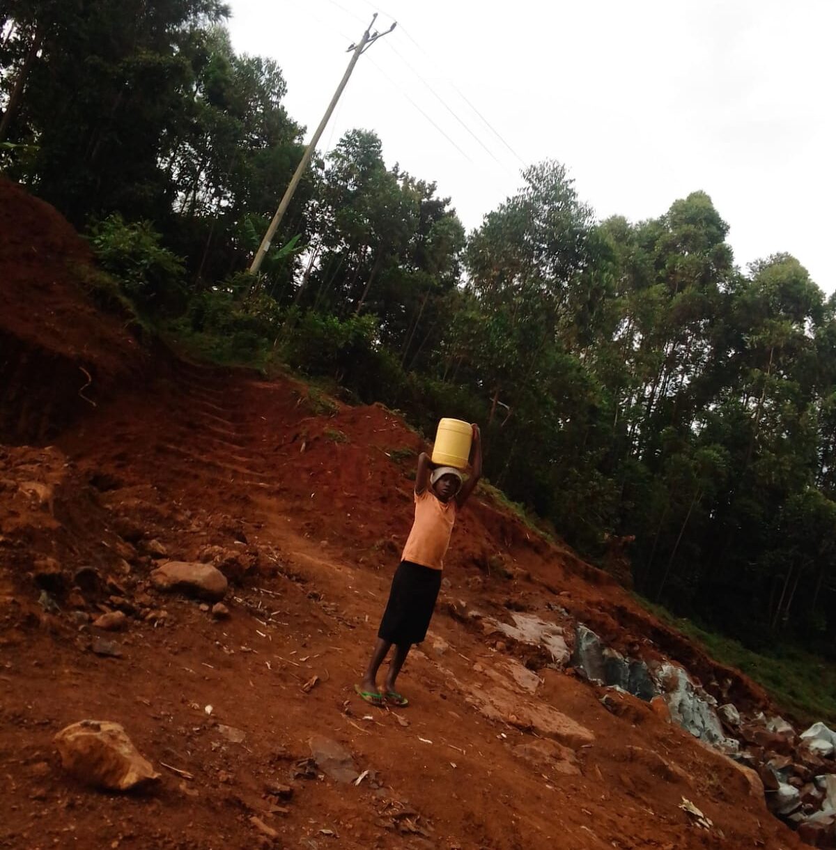 A girl fetching water from the Quarry pit at Magenche