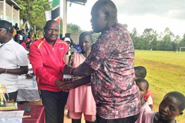 Senetwo Headteacher, Jonathan Lokudia receiving Position 1 trophy in Basketball in Rift Valley Region.