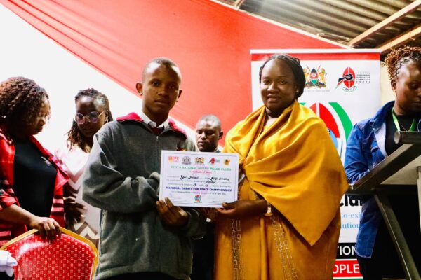 A student receives an award during the national debate competition held in Machakos. Photo/STEPHEN MUTHINI