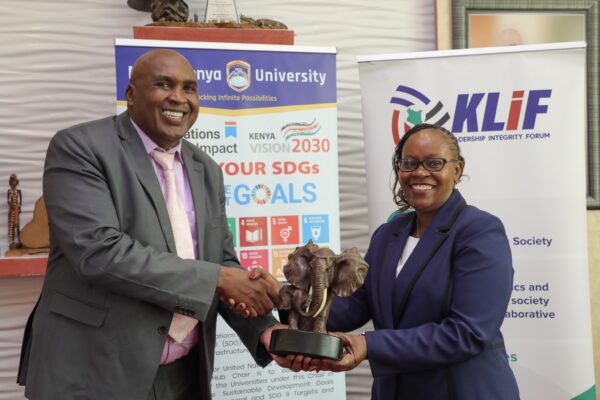 MKU chairman and founder Simon Gicharu appreciates Dr. Monica Wanjiru Muiru, Vice Chairperson EACC at MKU HQ.