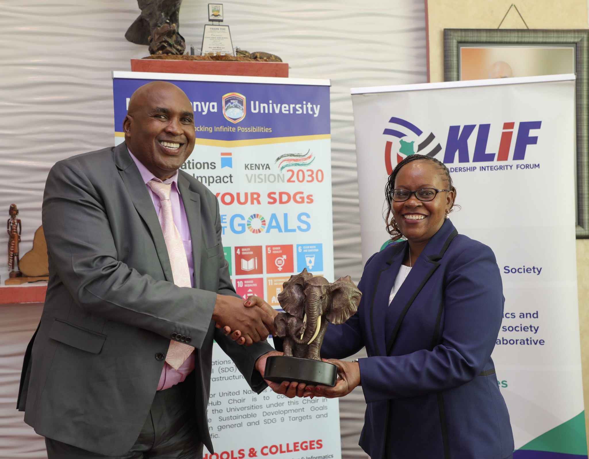 MKU chairman and founder Simon Gicharu appreciates Dr. Monica Wanjiru Muiru, Vice Chairperson EACC at MKU HQ.