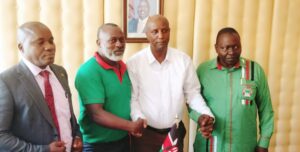Makueni KNUT Branch Executive Secretary Benson Ndambuki (second left) with outgoing TSC Director Abubakar Hassan and other education stakeholders during the handover ceremony.