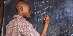 A learner writing on the board. The writer