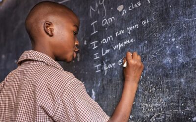 A learner writing on the board. The writer