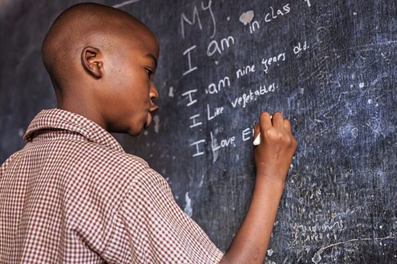 A learner writing on the board. The writer