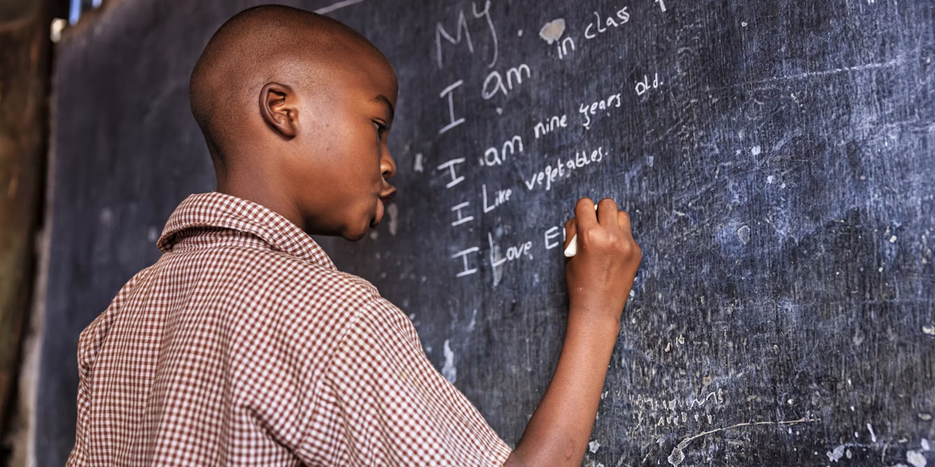A learner writing on the board. The writer