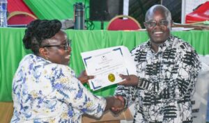 UASU secretary general Dr. Constatine Wesonga (r) receiving certificate after winning polls