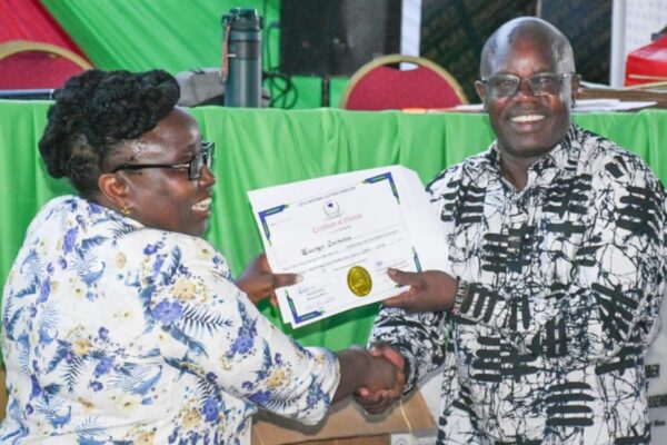 UASU secretary general Dr. Constatine Wesonga (r) receiving certificate after winning polls
