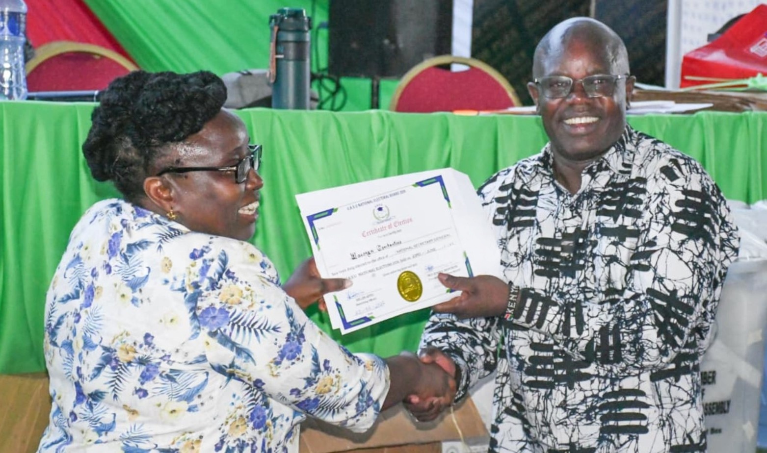 UASU secretary general Dr. Constatine Wesonga (r) receiving certificate after winning polls