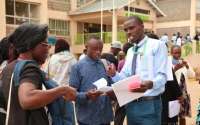 A first year student being guided on the admission process during admission day at Bomet University
