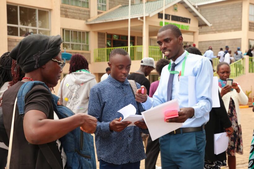 A first year student being guided on the admission process during admission day at Bomet University