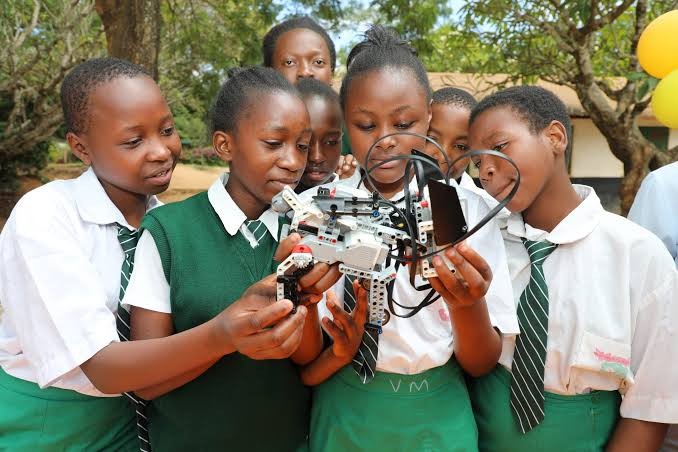 Pupils examine a robotics project during a science fair competition. Such events continue to nurture innovation and practical skills among learners in Kenyan schools.