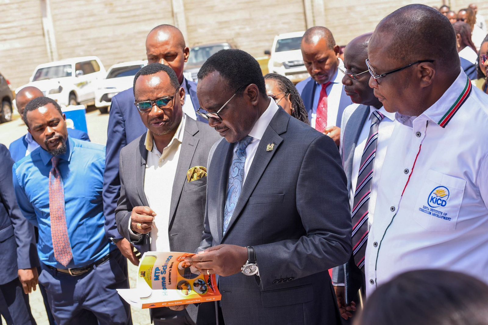 Education Cabinet Secretary Julius Ogamba inspects a Grade 10 textbook at English Press Ltd in Nairobi on January 22, 2026, ahead of their distribution to schools nationwide.