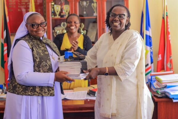 Outgoing Asumbi Girls Chief Principal Linet Sati welcomes her successor, Sr. Caroline Onyango, during the handing-over ceremony