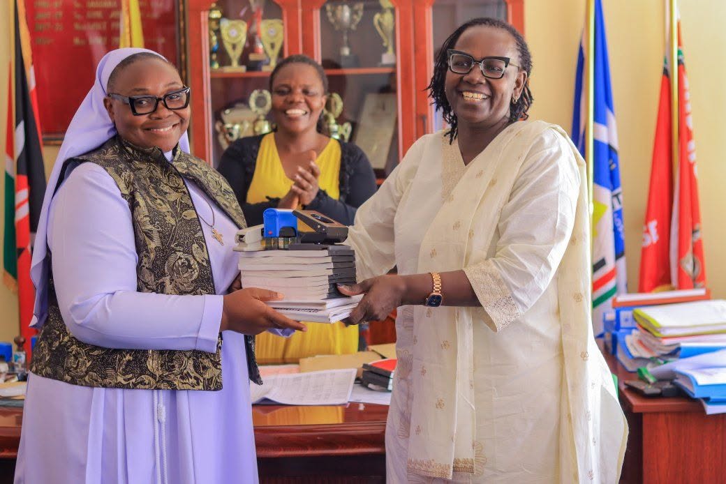 Outgoing Asumbi Girls Chief Principal Linet Sati welcomes her successor, Sr. Caroline Onyango, during the handing-over ceremony