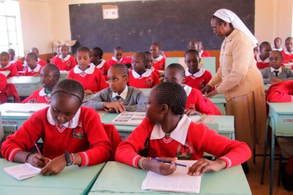 A teacher takes Grade Seven learners through their studies a