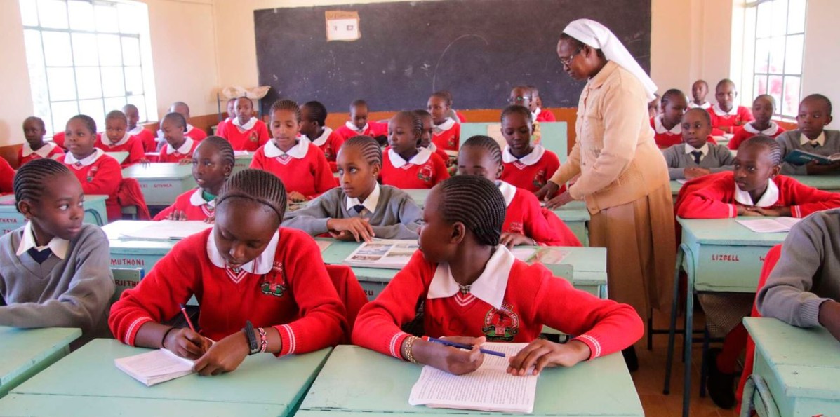 A teacher takes Grade Seven learners through their studies a