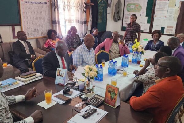 Chief Principal Clement Myang'acha( front right,) at his Kebirigo Senior School office with Principals from Nyamache Subcounty