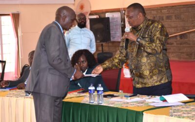 Gilbert Kiprono Sang (left) presents a petition to Baringo North MP Joseph Makilap (right), a member of the National Assembly Education Committee, during a public participation forum on the proposed Education Reform Bills in Narok