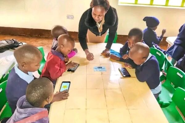 A tutor during an interactive Digital learning lesson at one of the ECDE Centres in Nyamira county
