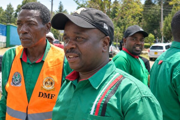 KNUT Secretary-General Collins Oyuu (left) with Bomet Branch Assistant Executive Secretary Geoffrey Bett (right) at Bomet Green Stadium recently