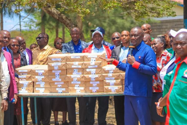 Matungulu MP Stephen Mule addresses teachers while holding revision text books for students to revise ahead of their final KPSEA and KCSE exams