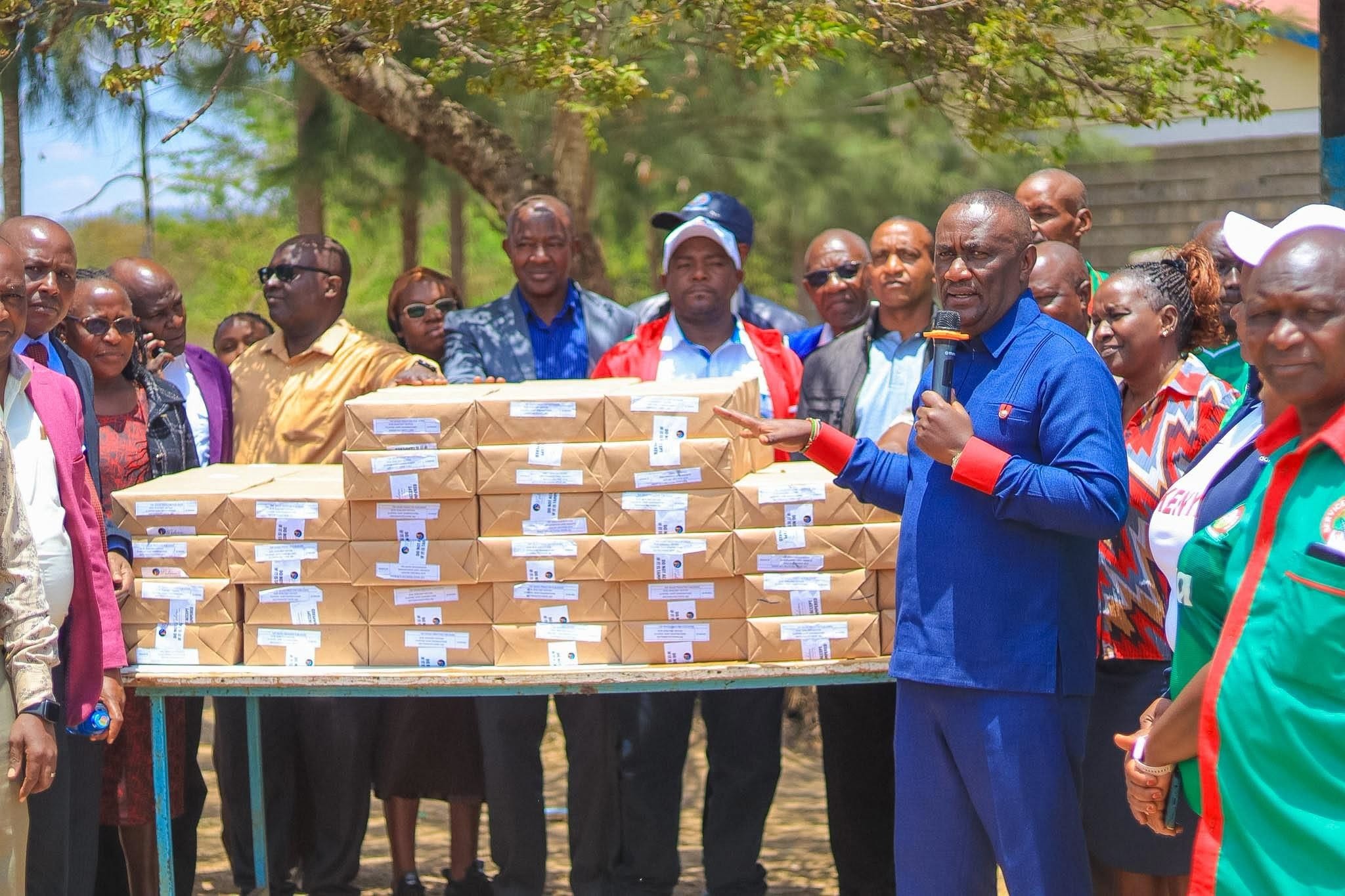 Matungulu MP Stephen Mule addresses teachers while holding revision text books for students to revise ahead of their final KPSEA and KCSE exams