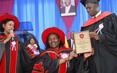 PS TVET Esther Muoria receives a gift from The Nairobi National Polytechnic CoG chair Charles Kimwomi during the graduation, looking on is Dr. Glory Mutungi, Chief Principal.