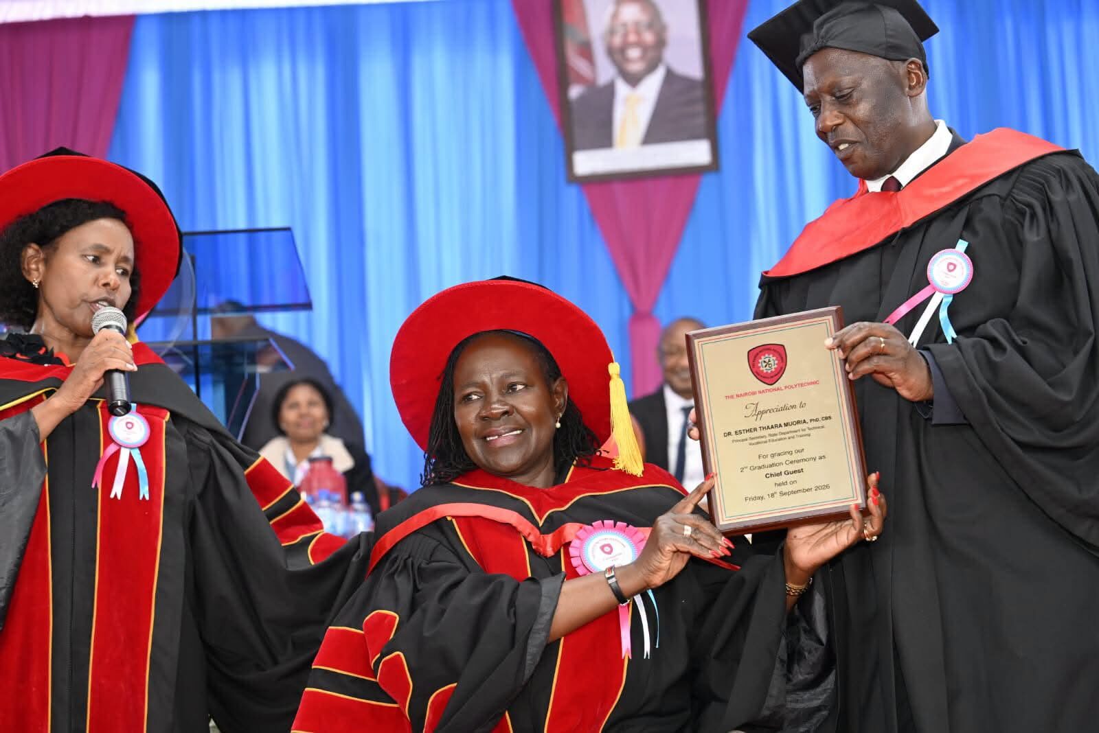 PS TVET Esther Muoria receives a gift from The Nairobi National Polytechnic CoG chair Charles Kimwomi during the graduation, looking on is Dr. Glory Mutungi, Chief Principal.