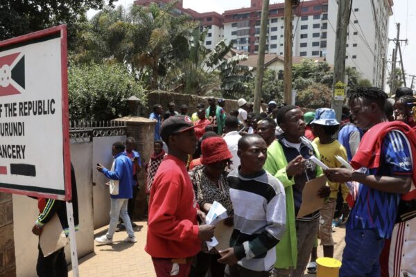 Burundi nationals stand outside their country's embassy as they seek travel documents to return home after a crackdown on foreign small-scale traders-Photo|Courtesy