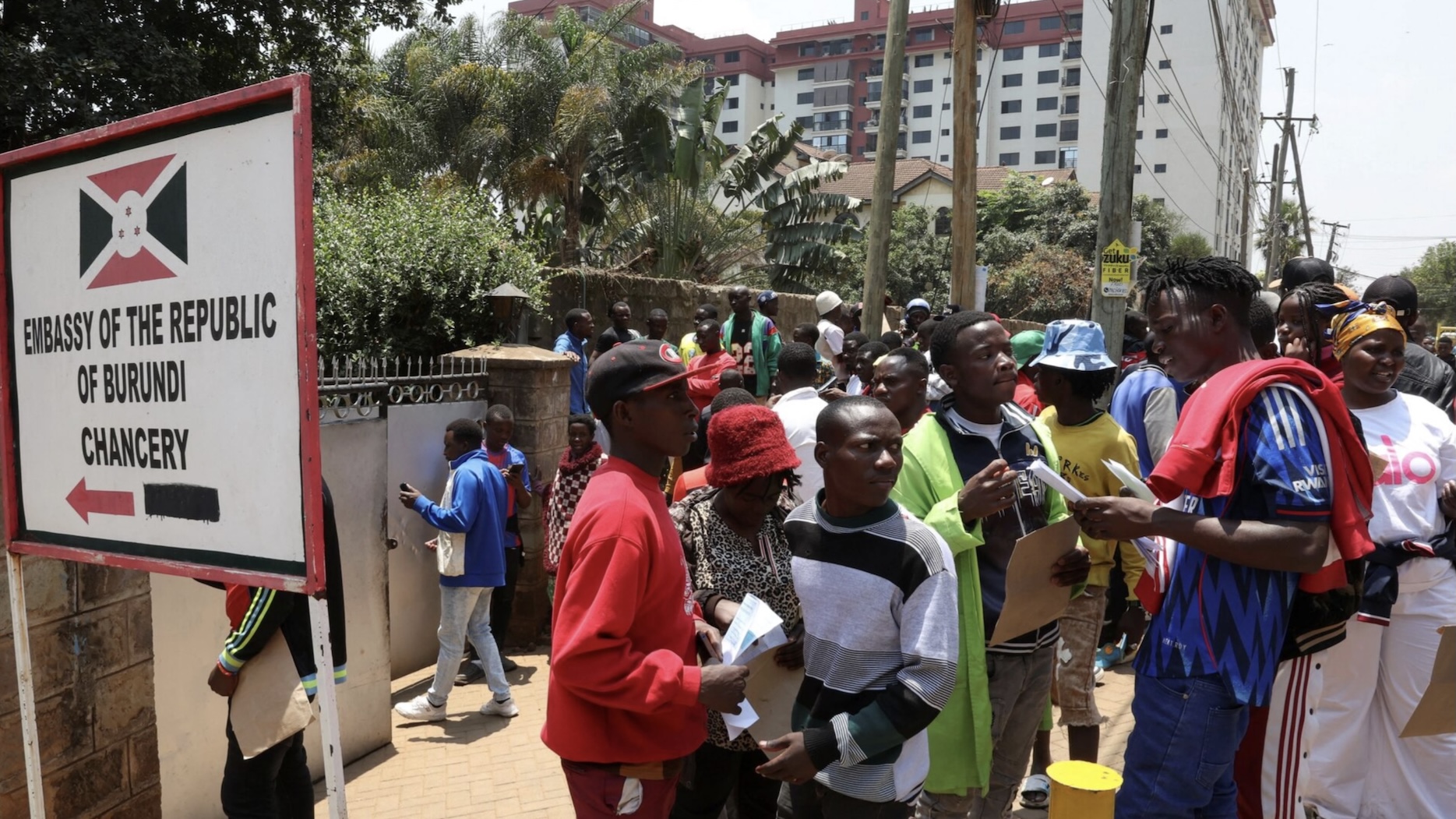 Burundi nationals stand outside their country's embassy as they seek travel documents to return home after a crackdown on foreign small-scale traders-Photo|Courtesy